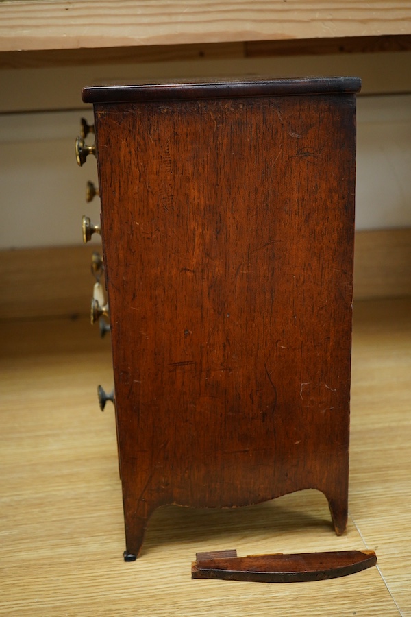 An early 20th century mahogany miniature chest of drawers, 39cm tall. Condition - one piece detached